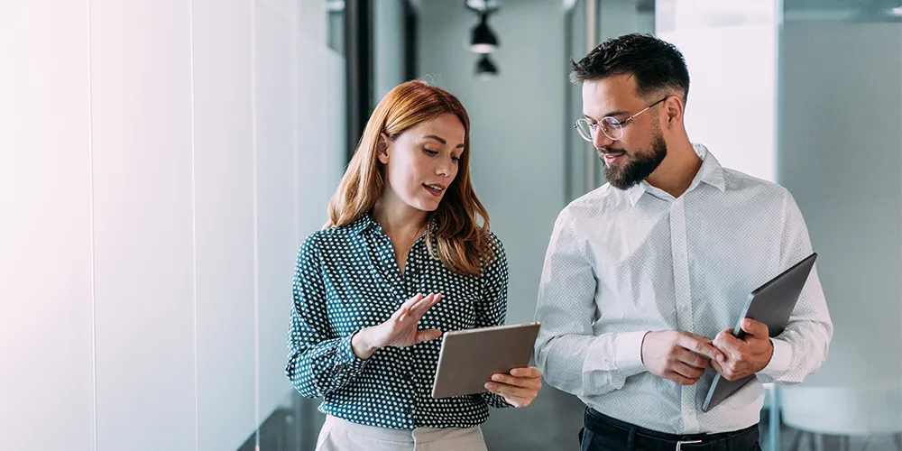 Eine Ärztin bespricht mit ihrem Berater die Fördermöglichkeiten einer Praxisfinanzierung.