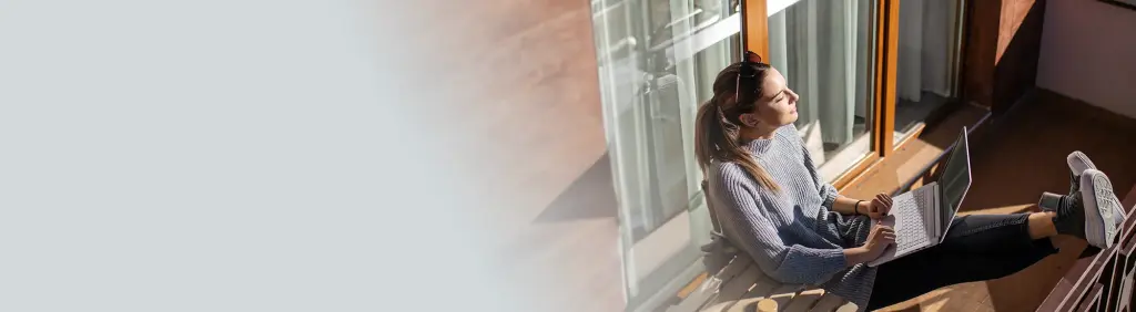 Altersvorsorgedepot / MLP / Junge Frau mit Laptop auf Balkon